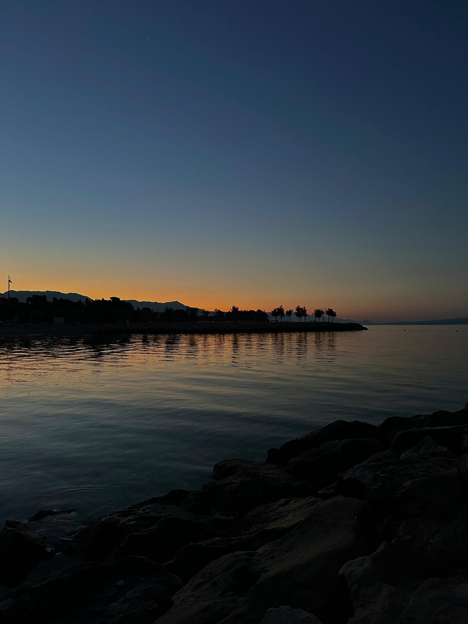 Adriatic sunset with rocky coast